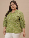 Plus-size woman in left side view wearing Green Plus Size Floral Top with floral pattern and relaxed fit