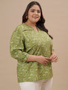 Plus-size woman in right side view wearing Green Plus Size Floral Top with lightweight fabric and floral design