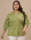 Plus-size woman walking in front view wearing Green Plus Size Floral Top with long sleeves and floral design