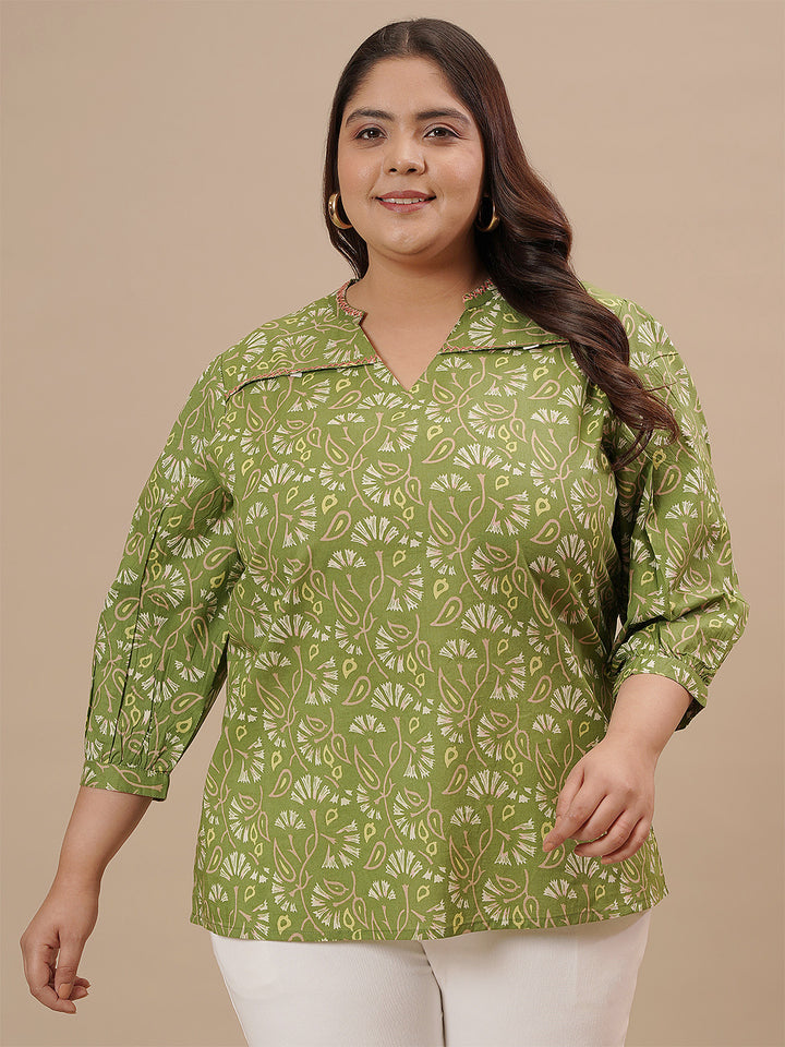 Plus-size woman walking in front view wearing Green Plus Size Floral Top with long sleeves and floral design
