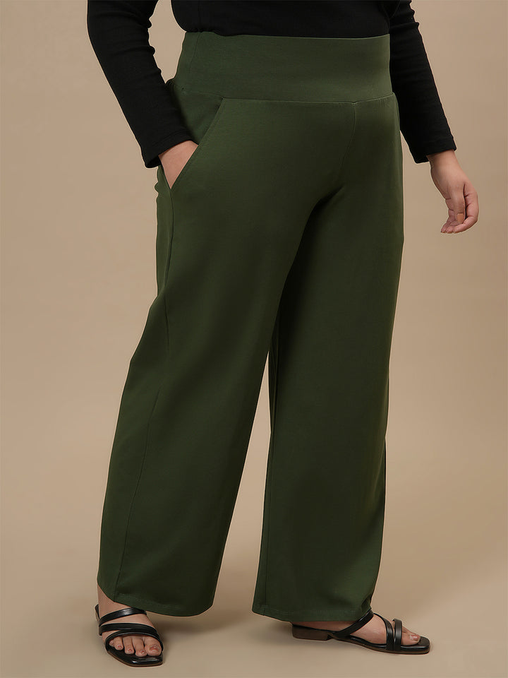 Plus-size woman in side angle view wearing Green Wide Leg Plus Size Pants with high-rise waist and soft drape