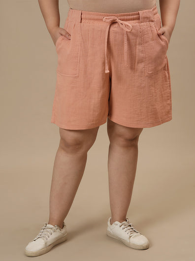 Plus-size woman in front view wearing High-Waisted Plus Size Cotton Shorts with relaxed fit and elastic waistband