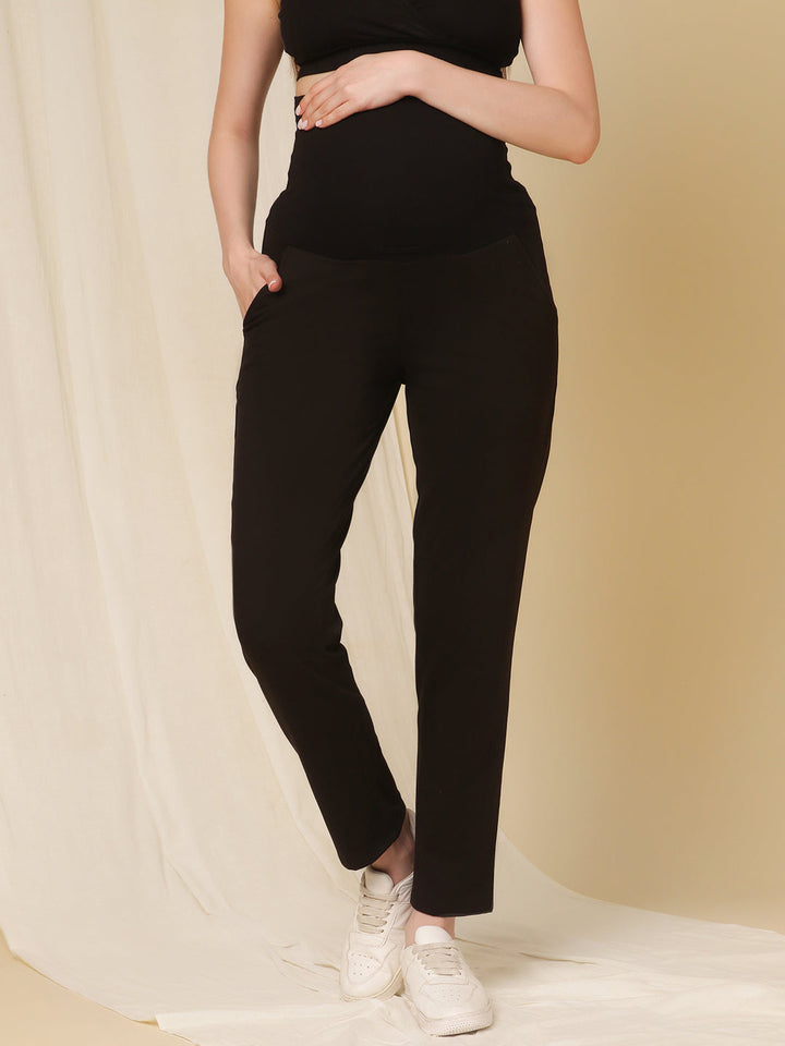 Front view of Wobbly Walk Black Maternity Fleece Pants featuring an over-belly, elastic-free waistband