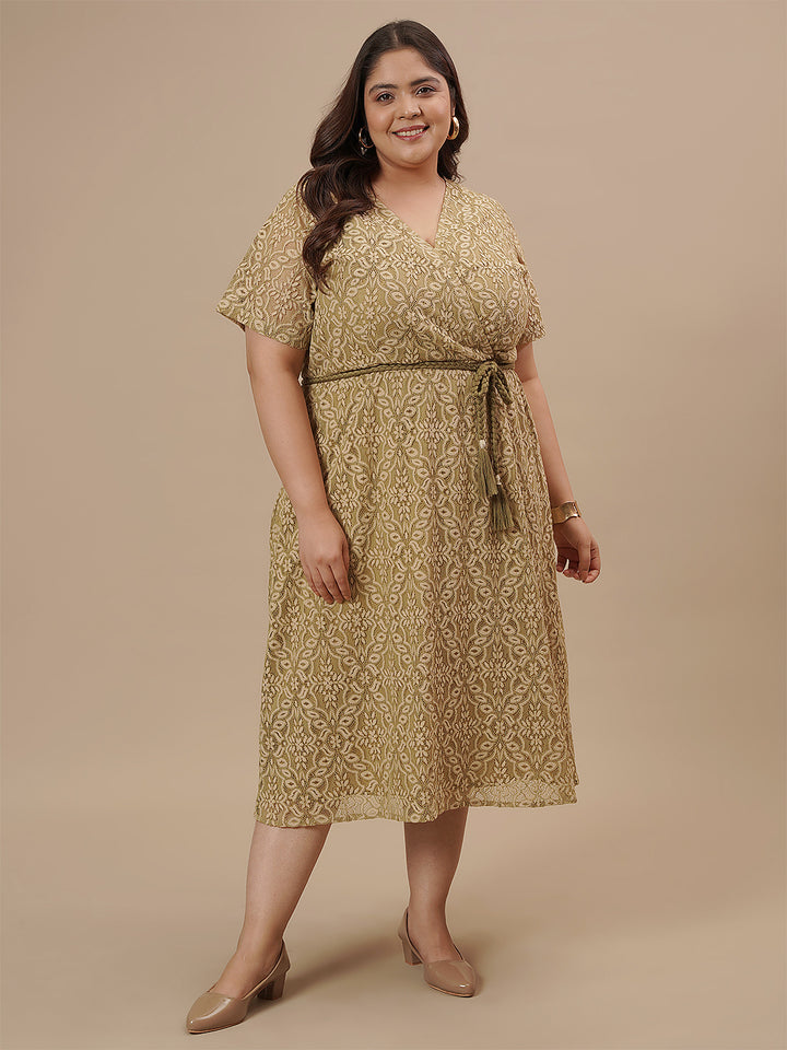 Plus-size woman in side front view wearing Olive Green Plus Size Lace Dress with V-neck and lace sleeves
