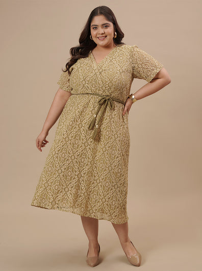 Plus-size woman in styled shoot wearing Olive Green Plus Size Lace Dress featuring sheer sleeves and lace detailing