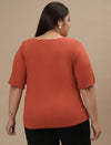 Plus-size woman in back view wearing Orange Plus Size V Neck Top with straight hem and relaxed fit