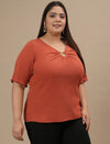 Plus-size woman in side angle view wearing Orange Plus Size V Neck Top with loose fit and flattering neckline