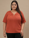 Plus-size woman in front view wearing Orange Plus Size V Neck Top featuring V neckline and short sleeves