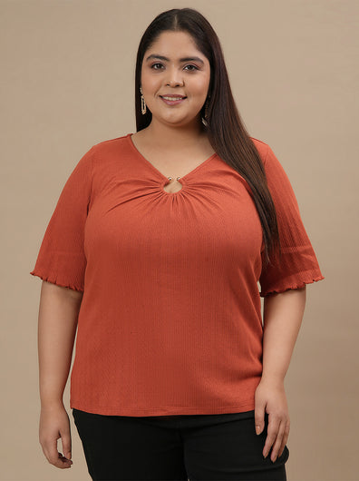 Plus-size woman in front view wearing Orange Plus Size V Neck Top featuring V neckline and short sleeves