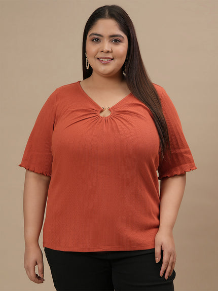 Plus-size woman in front view wearing Orange Plus Size V Neck Top featuring V neckline and short sleeves
