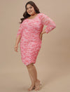 Plus-size woman smiling in front view wearing Pink Plus Size Bodycon Dress with fitted silhouette and scoop neck
