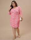 Plus-size woman walking with bag wearing Pink Plus Size Bodycon Dress featuring sleek fit and minimal design