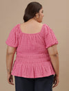 Plus-size woman in back view wearing Pink Plus Size Ruched Fitted Top with sleeveless design and snug fit