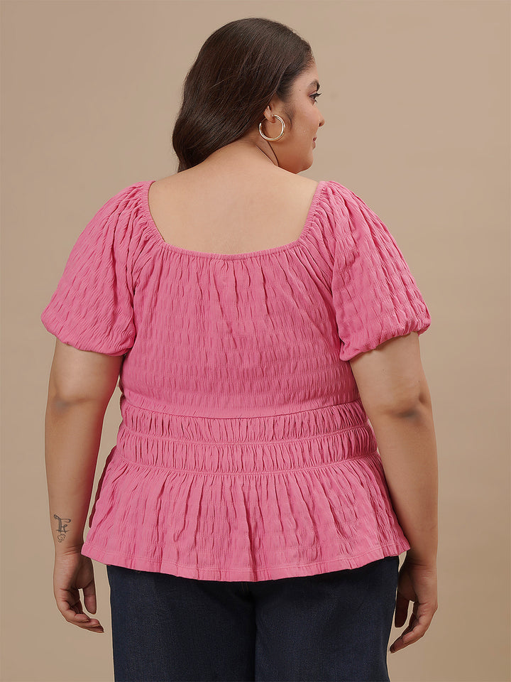 Plus-size woman in back view wearing Pink Plus Size Ruched Fitted Top with sleeveless design and snug fit