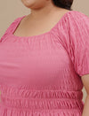 Close-up view of Pink Plus Size Ruched Fitted Top showing ruched detailing and stretch fabric texture