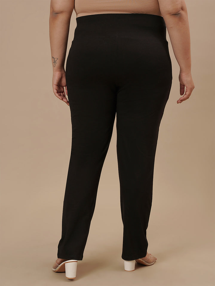 Plus-size woman in back view wearing Plus Size Black Casual Pants with relaxed back and minimal seams