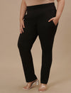 Plus-size woman highlighting front pocket of Plus Size Black Casual Pants with comfy fit and utility style