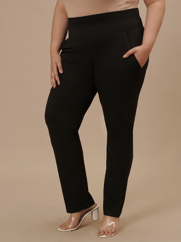 Plus-size woman highlighting front pocket of Plus Size Black Casual Pants with comfy fit and utility style
