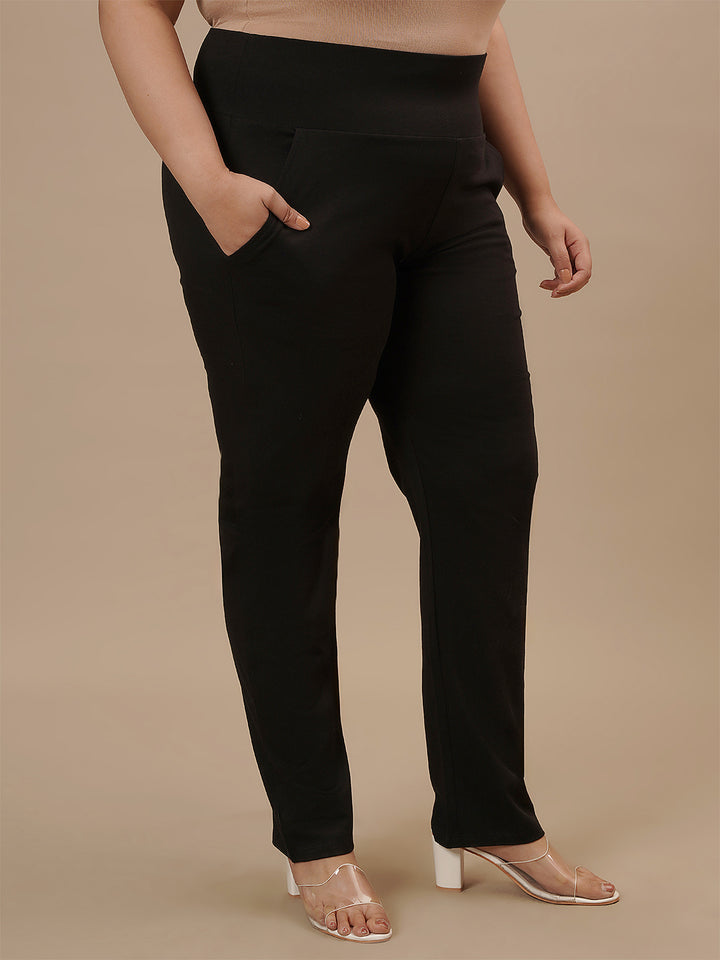 Plus-size woman in right side view wearing Plus Size Black Casual Pants with relaxed fit and straight leg