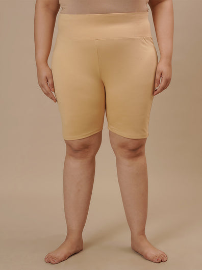 Plus-size woman in front view wearing Beige Plus Size Cycling Shorts with high-rise waist and snug fit