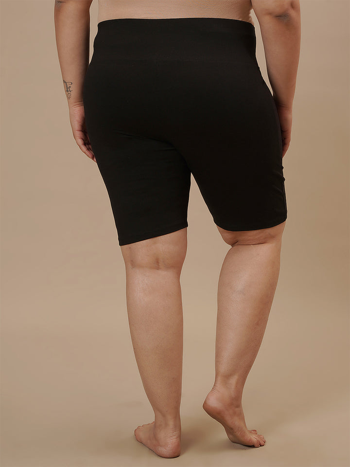 Plus-size woman in back view wearing Plus Size Cycling Shorts in Black with smooth back and secure waistband