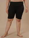Plus-size woman in front view wearing Plus Size Cycling Shorts in Black featuring fitted design and soft stretch