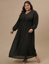 Plus-size woman in side profile wearing Plus Size Long Black Dress with flowy skirt and sheer sleeve
