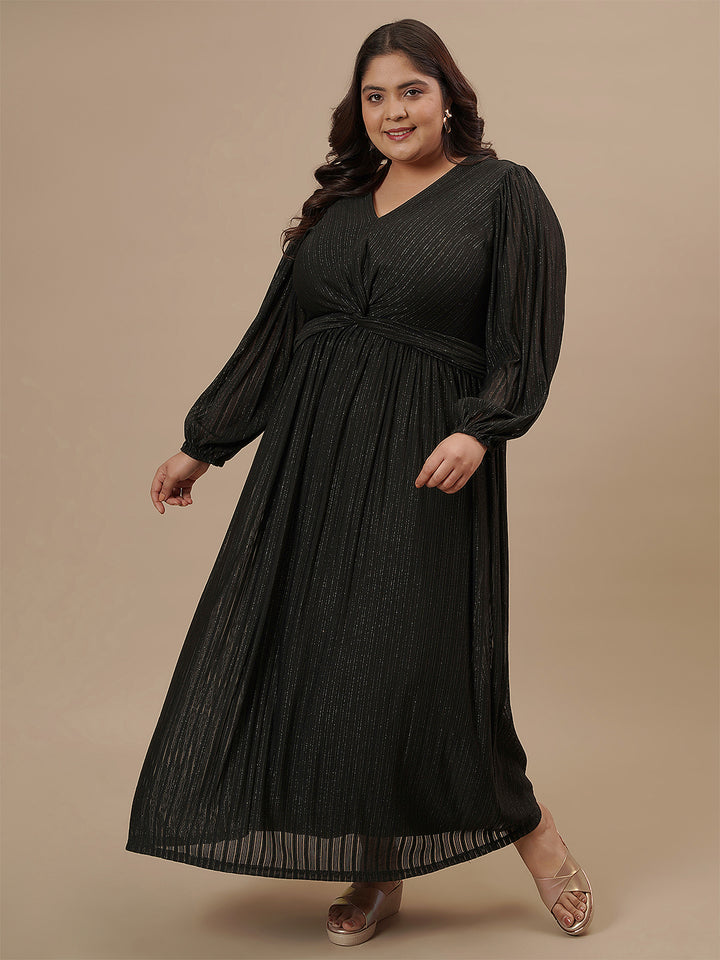 Plus-size woman in side profile wearing Plus Size Long Black Dress with flowy skirt and sheer sleeve