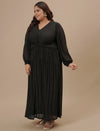 Plus-size woman in side view wearing Plus Size Long Black Dress featuring long sleeves and relaxed fit