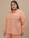 Plus-size woman in front left angle view wearing Plus Size Orange Cotton Top with curved hem and casual style