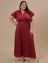 Plus-size woman in styled shoot wearing Plus Size Red Satin Gown featuring deep neckline and smooth satin fabric