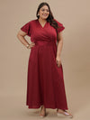 Plus-size woman in styled shoot wearing Plus Size Red Satin Gown featuring deep neckline and smooth satin fabric