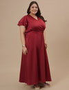 Plus-size woman in side pose wearing Plus Size Red Satin Gown with flowy silhouette and elegant satin finish