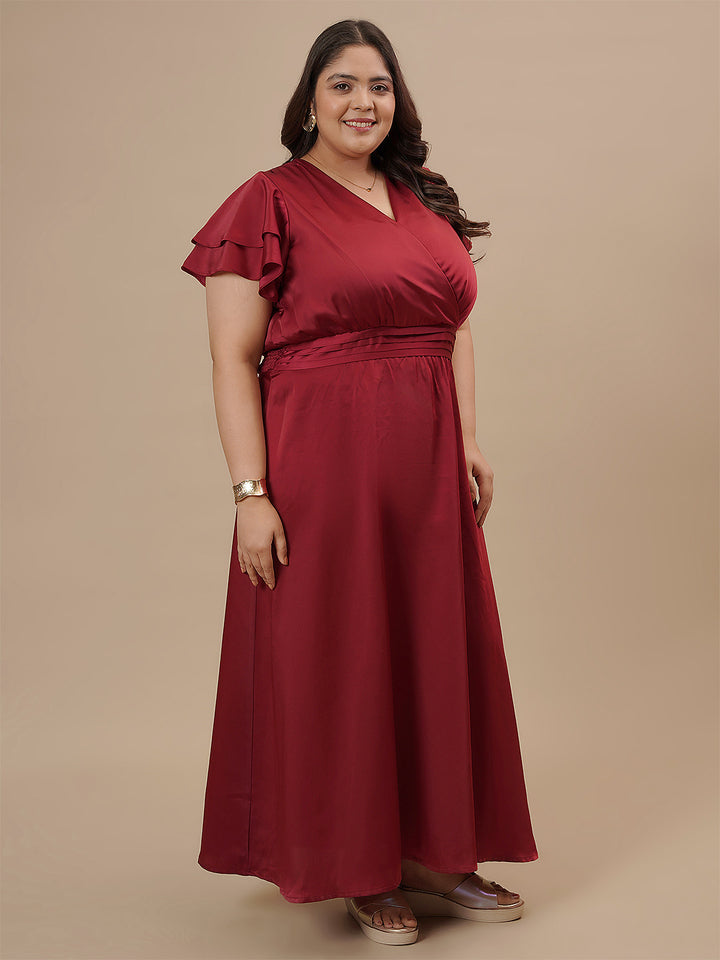 Plus-size woman in side pose wearing Plus Size Red Satin Gown with flowy silhouette and elegant satin finish