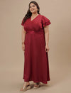 Plus-size woman in side view wearing Plus Size Red Satin Gown with draped fit and luxurious sheen
