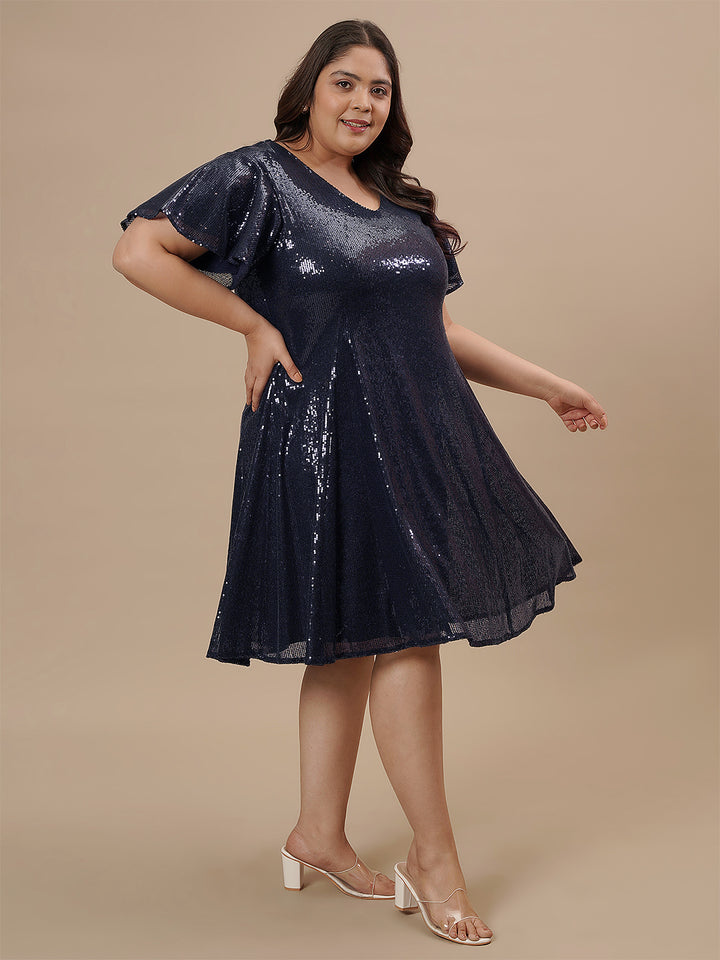 Plus-size woman in right side view wearing Plus Size Sequin Blue Dress with sleeveless cut and sparkling finish