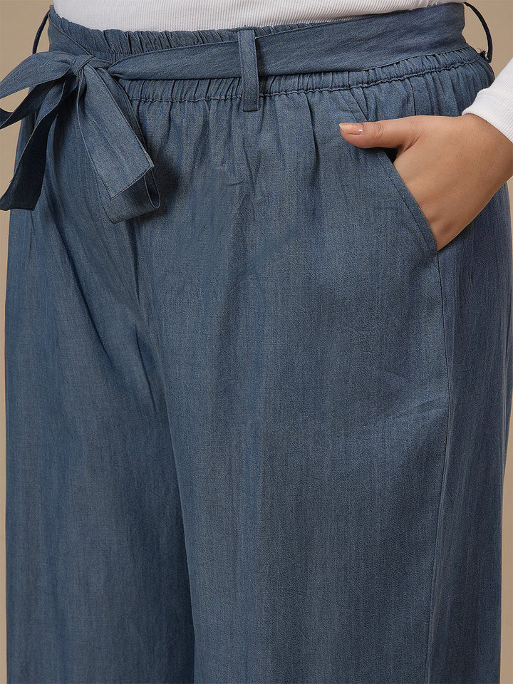 Close-up view of Plus Size Wide Leg Jeans in blue showing waistband and denim texture