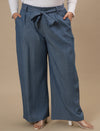 Plus-size woman in front view wearing Plus Size Wide Leg Jeans in blue with high waist and roomy leg cut