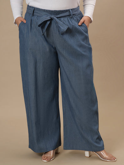 Plus-size woman in front view wearing Plus Size Wide Leg Jeans in blue with high waist and roomy leg cut