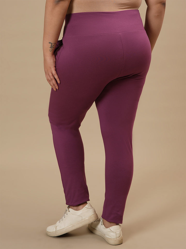 Plus-size woman in back side view wearing Purple Plus Size Leggings With Pockets with fitted shape and smooth back