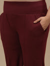 Close-up view of Red Plus Size Flare Pants showing pocket detail and smooth fabric texture
