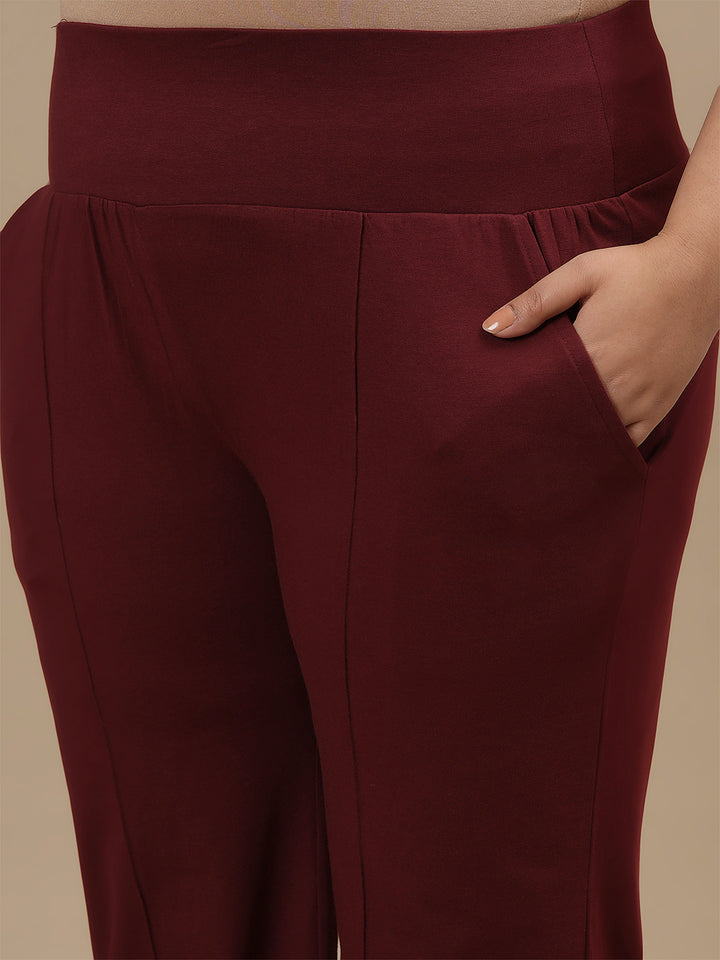 Close-up view of Red Plus Size Flare Pants showing pocket detail and smooth fabric texture