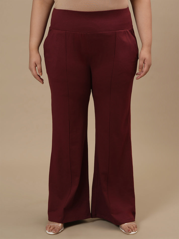 Plus-size woman in front view wearing Red Plus Size Flare Pants featuring wide leg and clean finish