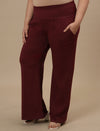 Plus-size woman in side view wearing Red Plus Size Flare Pants with high-rise waist and flared leg design