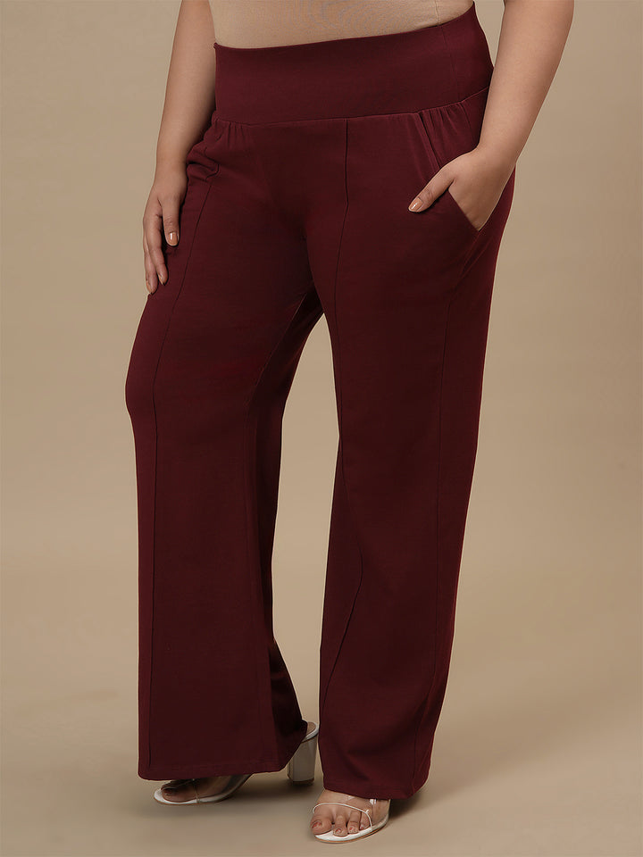 Plus-size woman in side view wearing Red Plus Size Flare Pants with high-rise waist and flared leg design