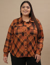 Plus-size woman in front view wearing Rust Brown Plus Size Shirt Jacket with long sleeves and chest pockets