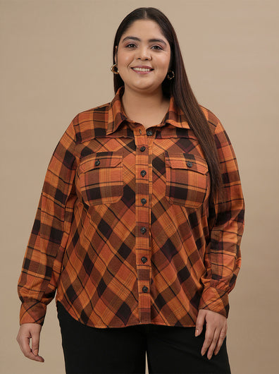 Plus-size woman in front view wearing Rust Brown Plus Size Shirt Jacket with long sleeves and chest pockets