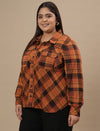 Plus-size woman in left side view wearing Rust Brown Plus Size Shirt Jacket with button-down closure and relaxed fit