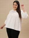 Plus-size woman in side angle view wearing White Cotton Plus Size Top with full sleeves and breathable cotton fabric
