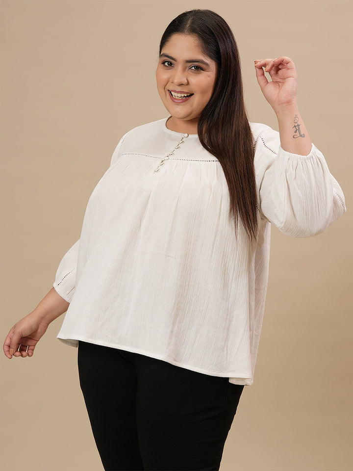 Plus-size woman in side angle view wearing White Cotton Plus Size Top with full sleeves and breathable cotton fabric